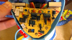 Fisher-Price swing control PCB with fried transistor removed to show scorch marks